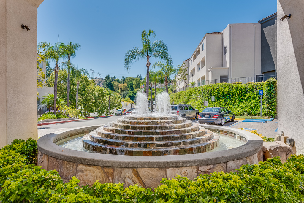 stone water fountain in front of building