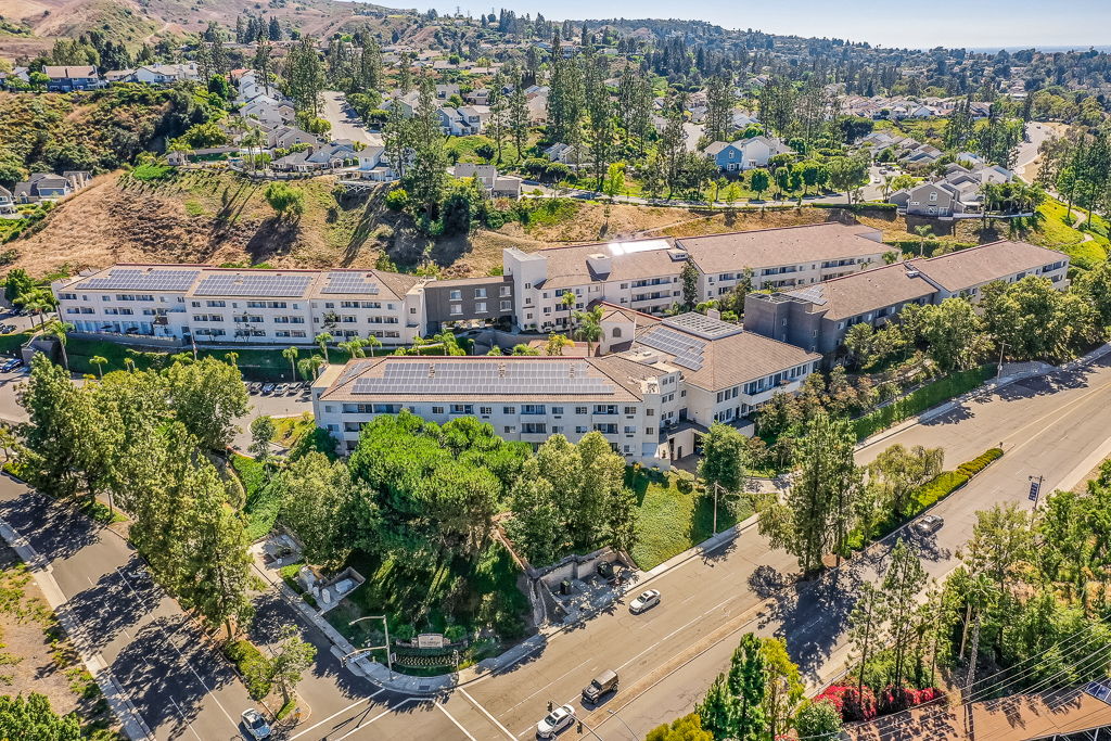 aerial view of property surrounded by trees